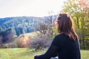 Photo of a woman sitting outside on the ground. Learn tips on how to keep your holiday anxiety in Gallatin, TN down. Be stress-free this holiday season.