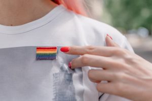 Photo of someone wearing a pride flag pin on their shirt and pointing to it. Do you know someone who is in the LGBTQIA+ community? Learn tips on how to provide support in the LGBTQ community in Gallatin, TN. Click here to learn more!