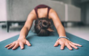 Photo of a woman practicing yoga. This photo represents how exercise and mindfulness meditation can help you with your depression symptoms. With online depression treatment in Gallatin, TN you can learn to manage your depression symptoms.