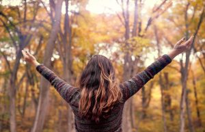 Photo of a woman raising her hands above her head. This photo represents how a depression therapist in Gallatin, TN can help you break free of your depression symptoms and begin healing. Click here to learn more.