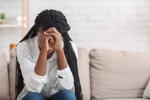 A teen rests her head against her hands while sitting with an upset expression. Learn more about teenage counseling in Gallatin, TN by searching "counseling for teens near me" or contacting a teenage therapist in Gallatin, TN today.