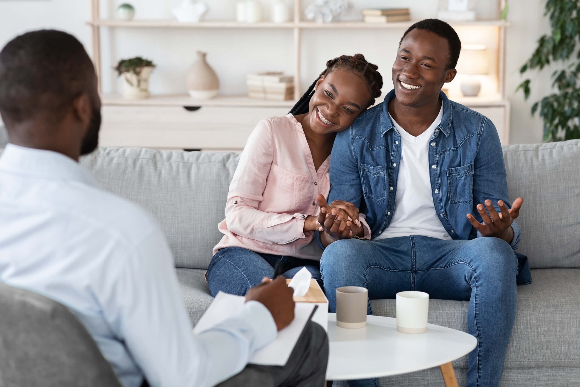 family counseling young happy black couple sitting on couch