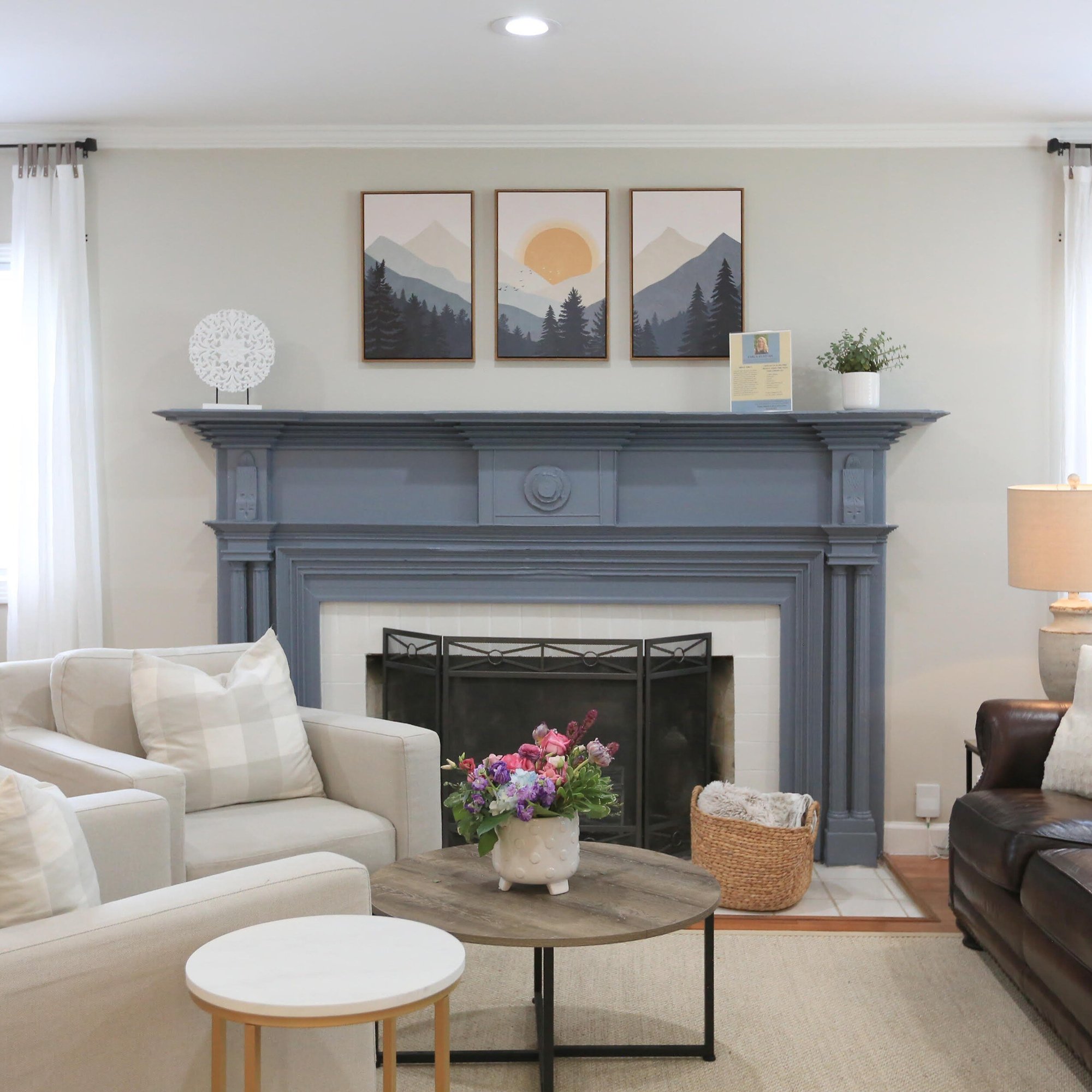 TN Mental Wellness inside office with two white chairs and one brown counch in front of light blue fireplace and two sun-lit windows-1