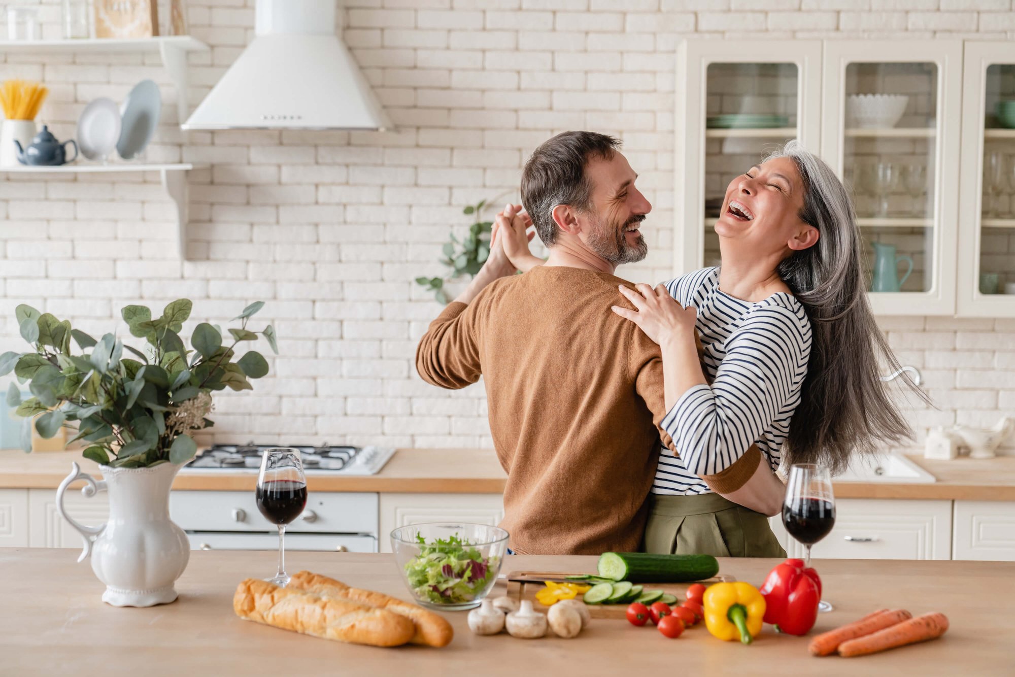 TN-Mental-Wellness-Couples-Therapy-old-man-old-lady-dancing-in-kitchen-smiling