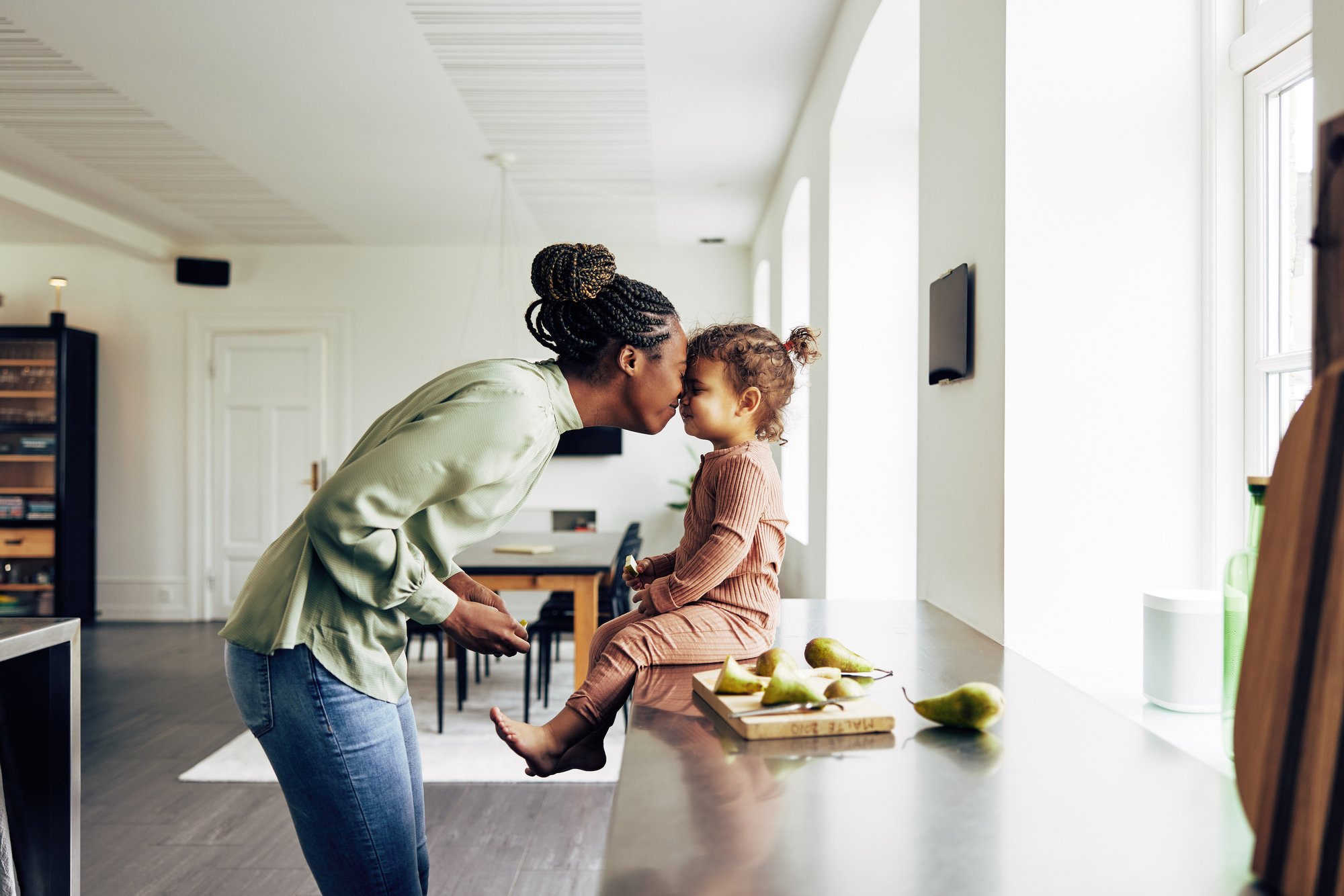 TNMental Wellness black woman nose snuggles to a small child sitting on counter